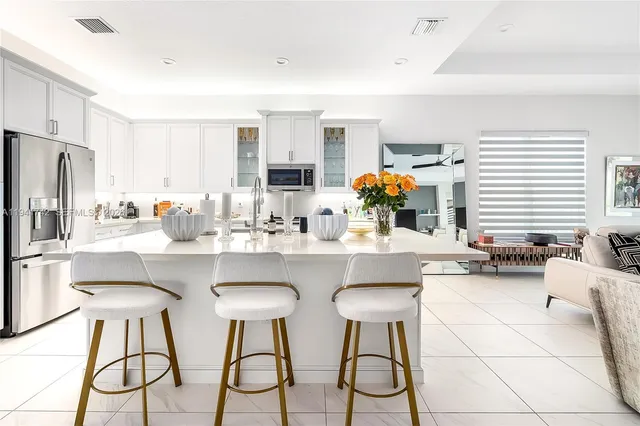 a kitchen with granite countertop white cabinets and sink