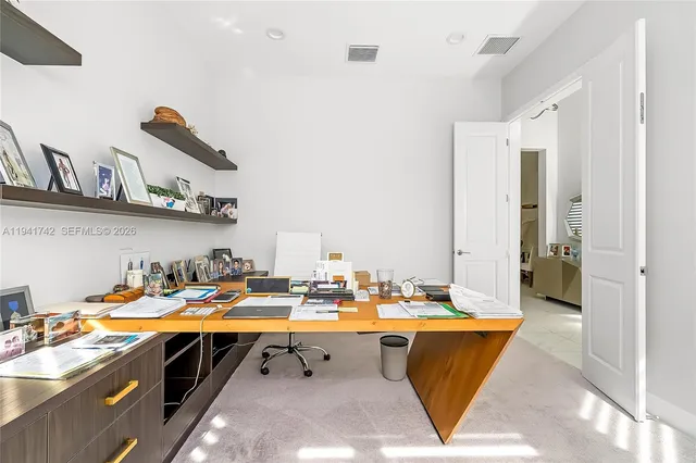 a bedroom with furniture and a flat screen tv