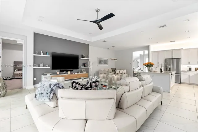 a kitchen with stainless steel appliances a sink dishwasher stove refrigerator and cabinets