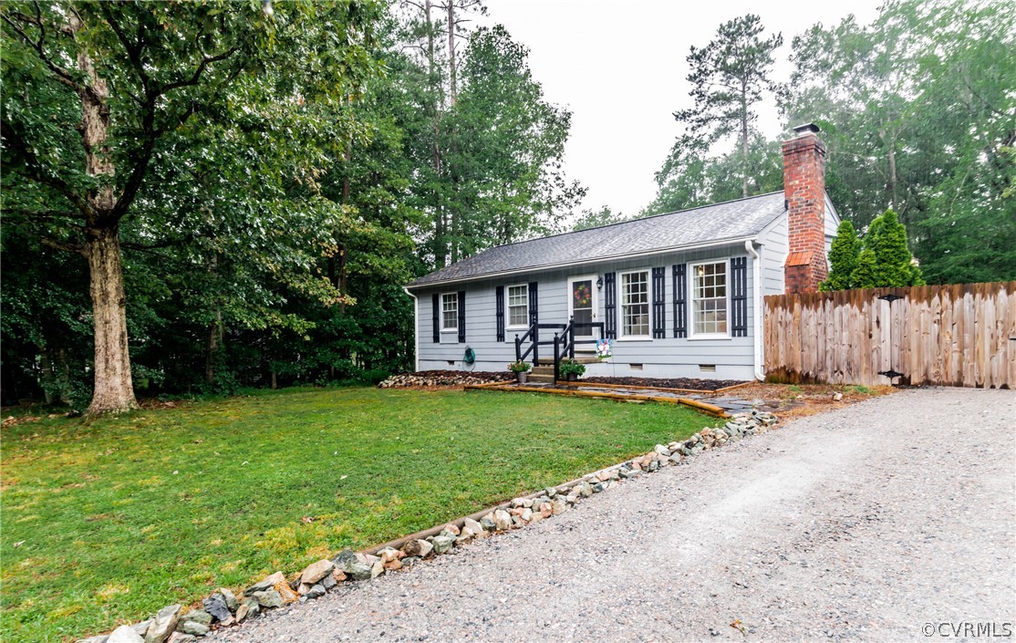 a front view of a house with yard patio and green space