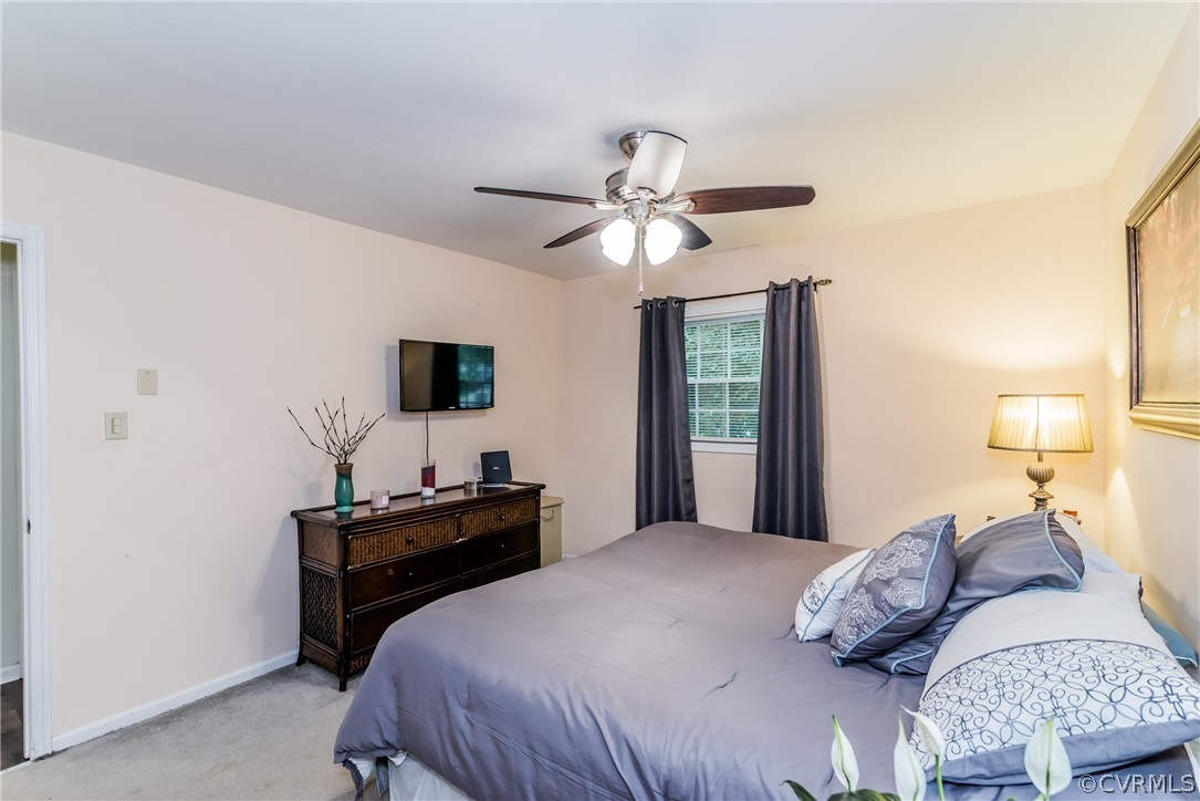 5242 Rollingway Road Chesterfield, VA 23832 - Photo 12 of 24 a bedroom with a bed and a chandelier