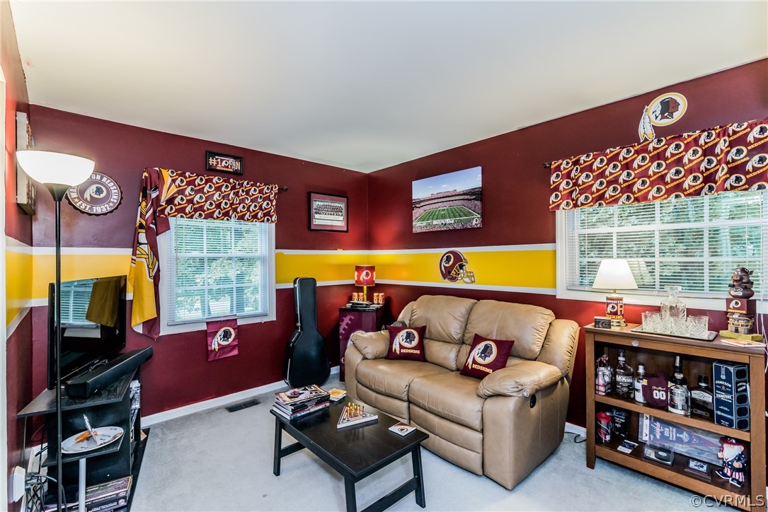 5242 Rollingway Road Chesterfield, VA 23832 - Photo 14 of 24 a living room with furniture a flat screen tv and a floor to ceiling window