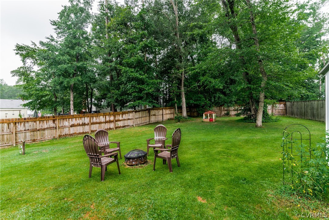 5242 Rollingway Road Chesterfield, VA 23832 - Photo 20 of 24 a view of yard with couple of trees and outdoor seating