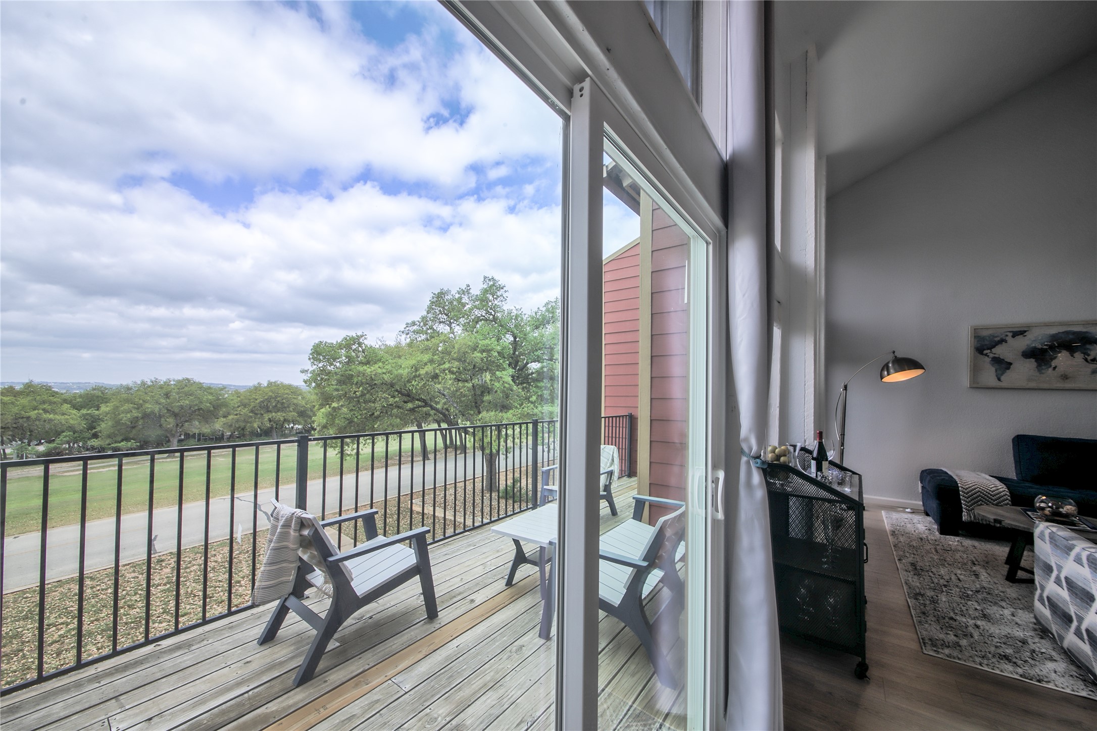 549 Demarett Drive Point Venture, TX 78645 - Photo 13 of 31 a view of a balcony with chair and floor to ceiling window