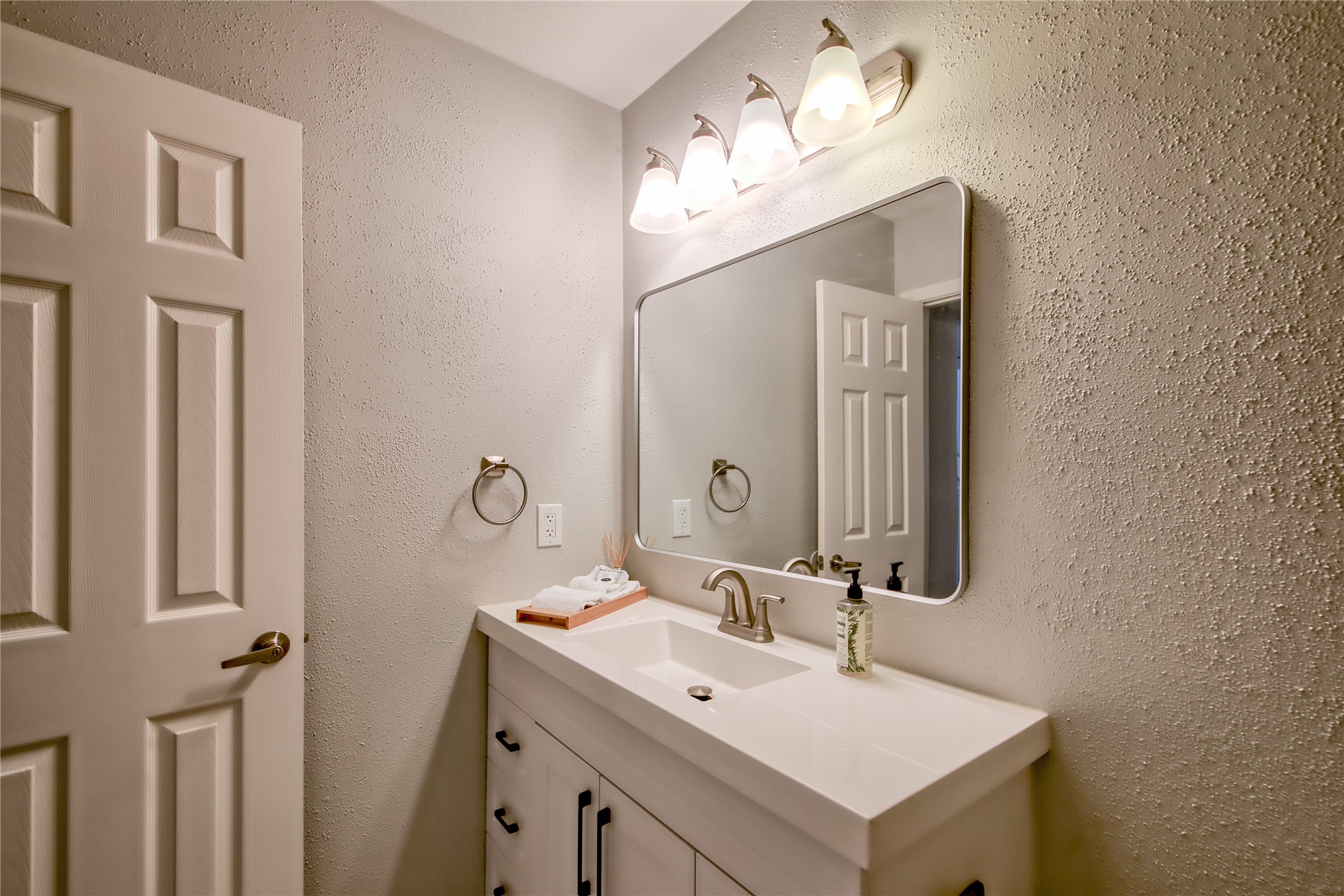 549 Demarett Drive Point Venture, TX 78645 - Photo 15 of 31 a bathroom with a sink and a mirror