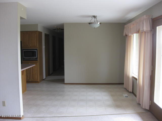 9530 Mieras Road Yakima, WA 98901 - Photo 11 of 55 a view of a kitchen with a refrigerator and cabinets