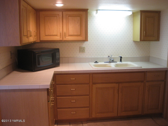 9530 Mieras Road Yakima, WA 98901 - Photo 33 of 55 a kitchen with a sink and cabinets