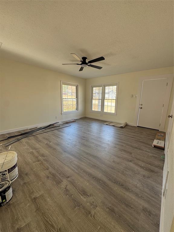 214 East Acheson Street Denison, TX 75021 - Photo 12 of 20 an empty room with wooden floor and windows