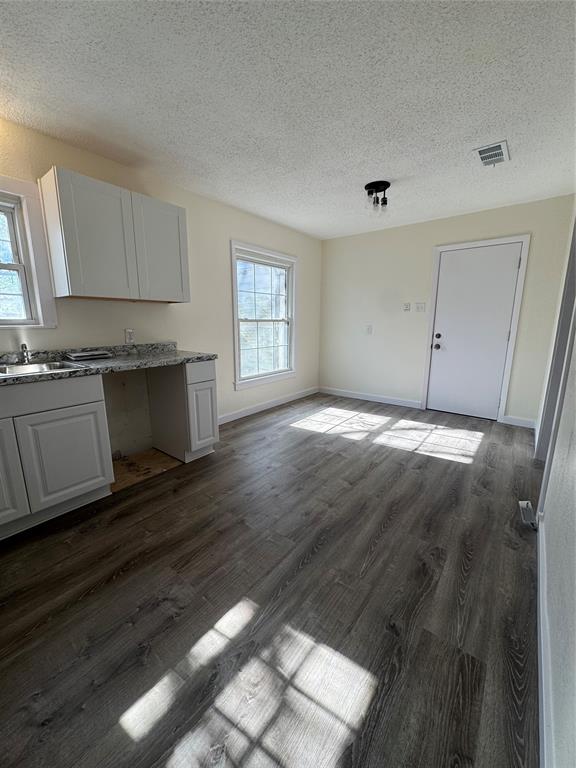 214 East Acheson Street Denison, TX 75021 - Photo 16 of 20 a view of a kitchen with granite countertop cabinets and wooden floor