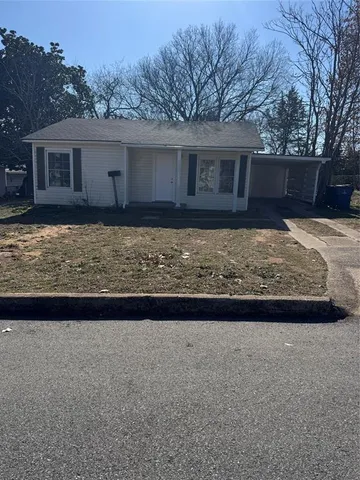 a view of house with backyard and tree