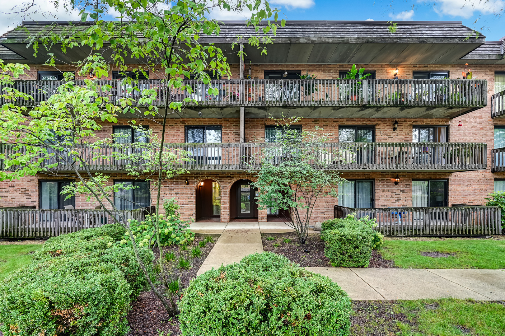 444 Redondo Drive, Unit 205 Downers Grove, IL 60516 - Photo 1 of 21 a house with a tree in front of it