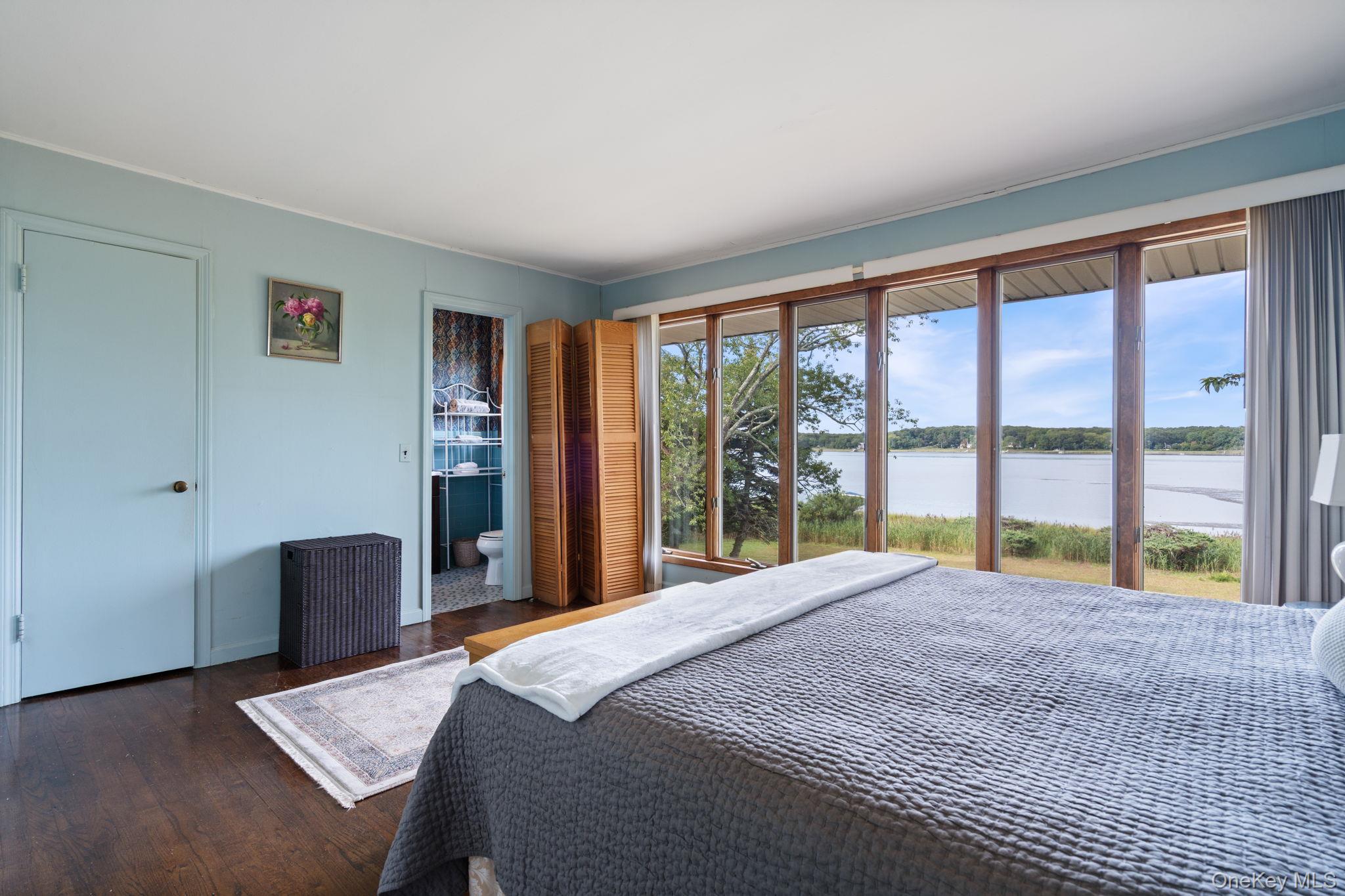 24 Conscience Circle Setauket, NY 11733 - Photo 13 of 31 a bedroom with a bed and glass window