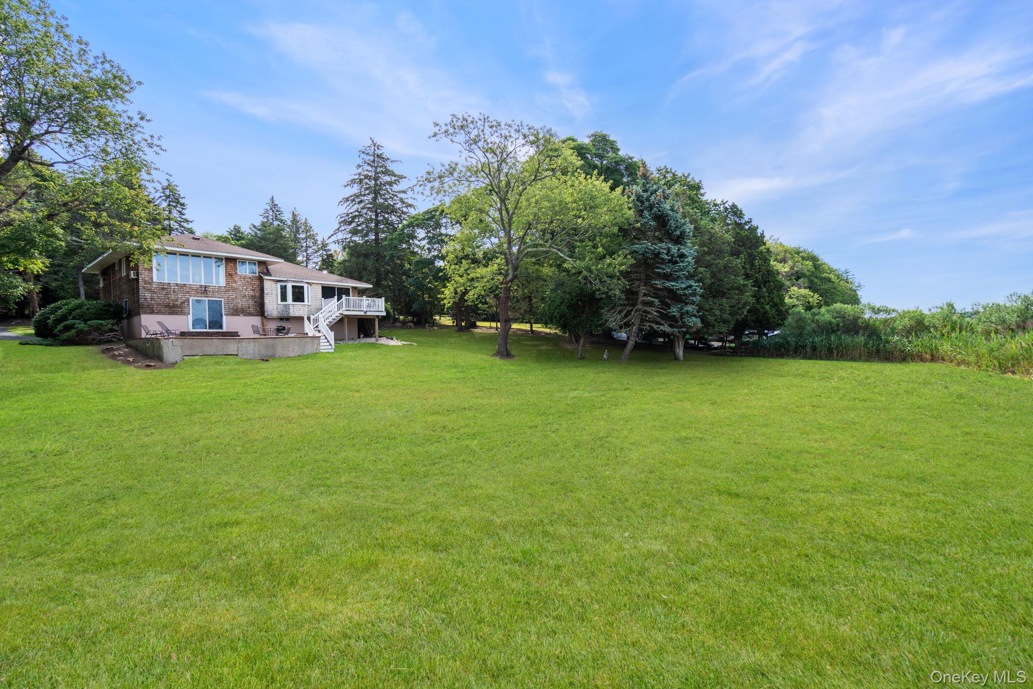 24 Conscience Circle Setauket, NY 11733 - Photo 20 of 31 a view of a house with a big yard and large trees
