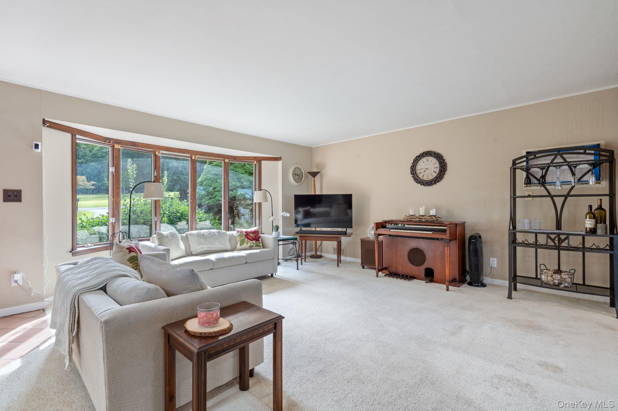 24 Conscience Circle Setauket, NY 11733 - Photo 5 of 31 a living room with furniture a fireplace and a flat screen tv