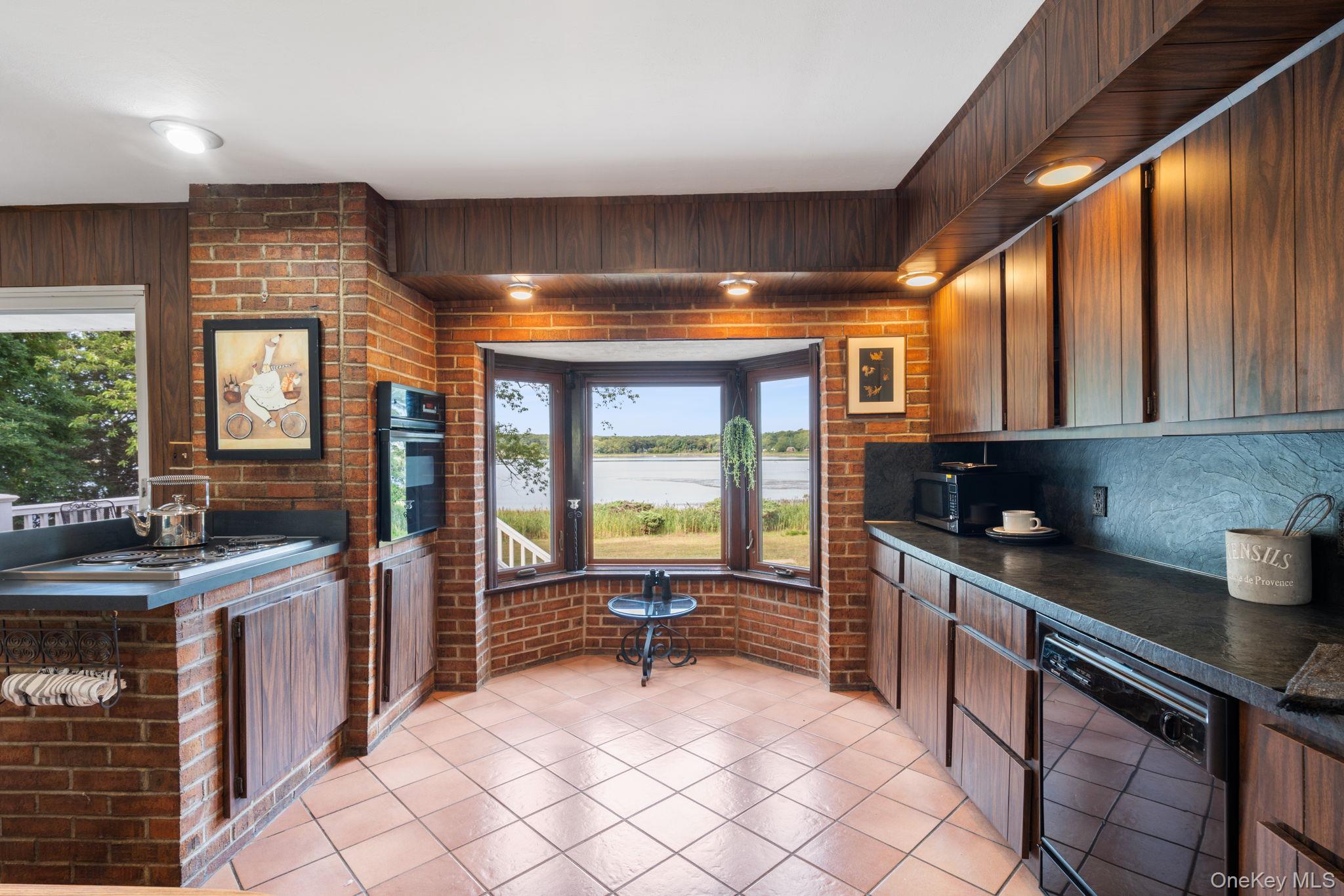 24 Conscience Circle Setauket, NY 11733 - Photo 7 of 31 a kitchen with granite countertop a sink and a stove