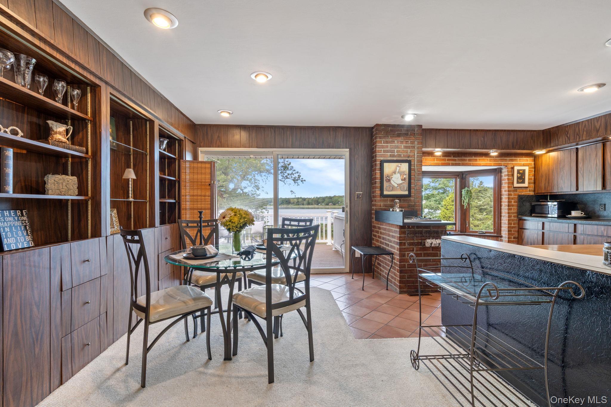 24 Conscience Circle Setauket, NY 11733 - Photo 9 of 31 a dining room with furniture and a large window
