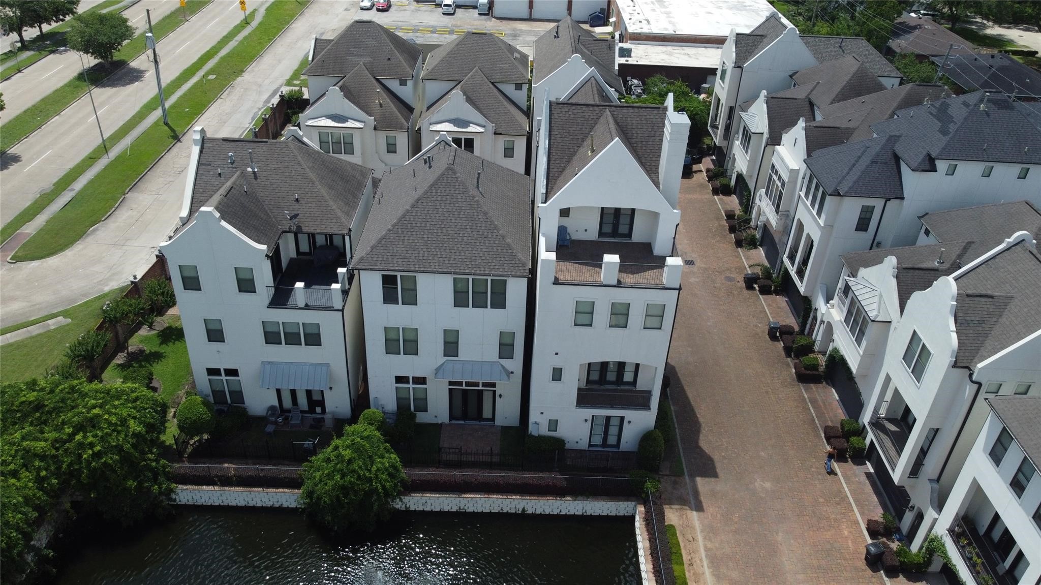 a front view of a multi story building with yard