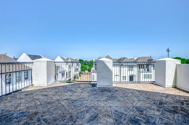 a view of a house with a small yard and wooden fence