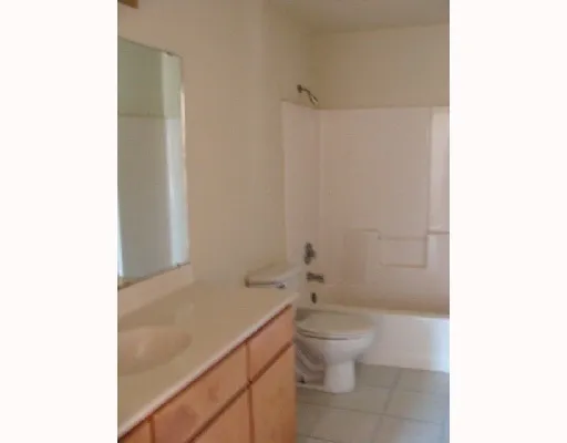 a bathroom with a toilet a sink and shower