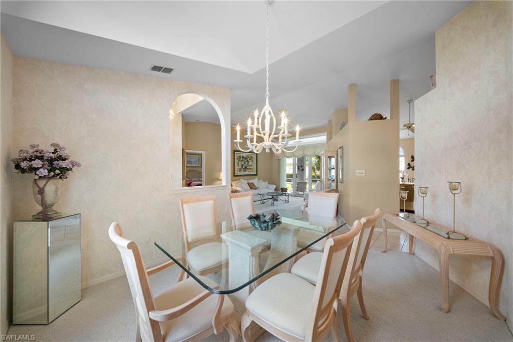 3971 Spring Garden Lane Estero, FL 33928 - Photo 17 of 31 a dining room with furniture and chandelier