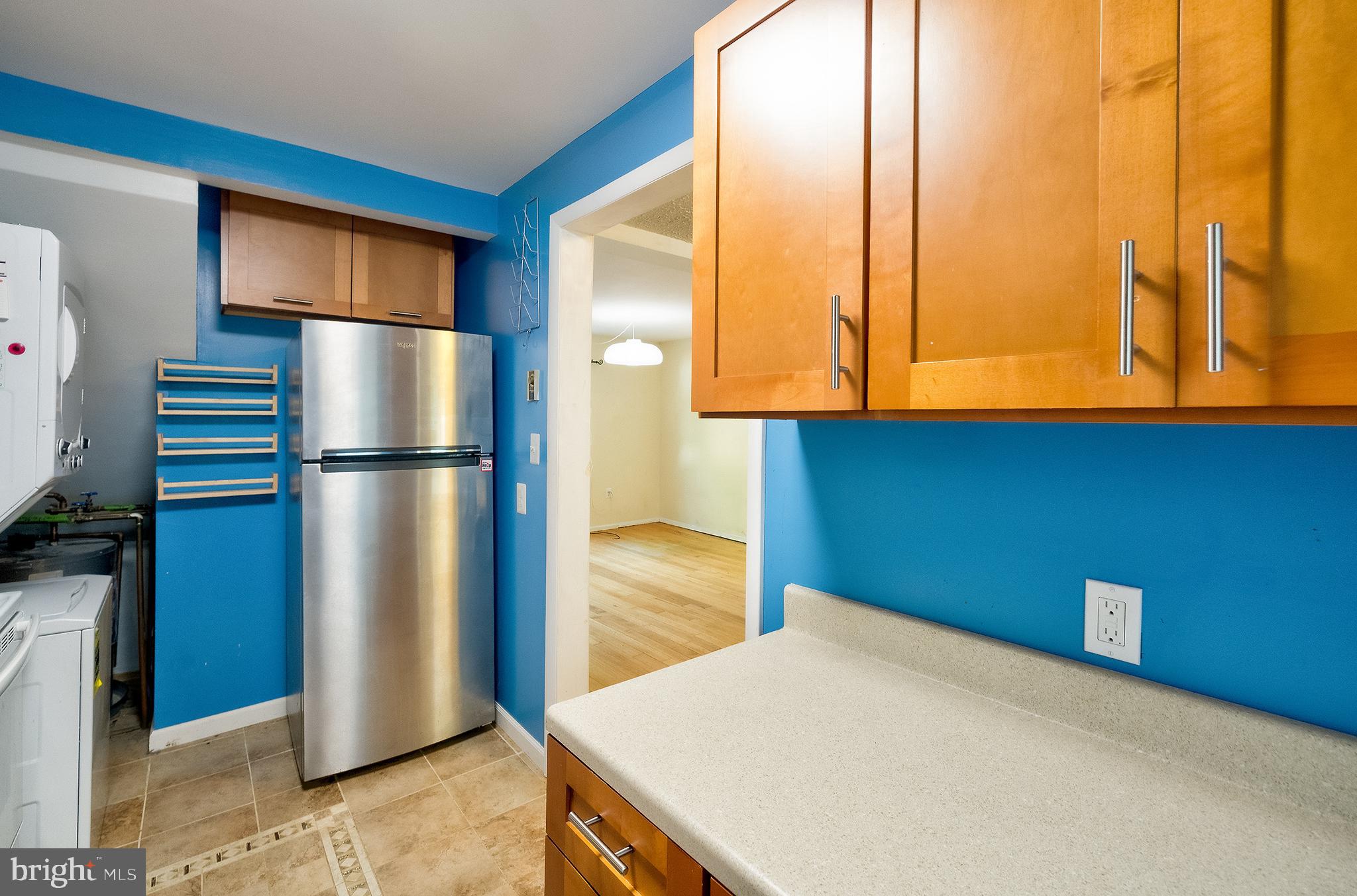 52 Ridge Road Greenbelt, MD 20770 - Photo 15 of 35 a kitchen with a refrigerator and cabinets