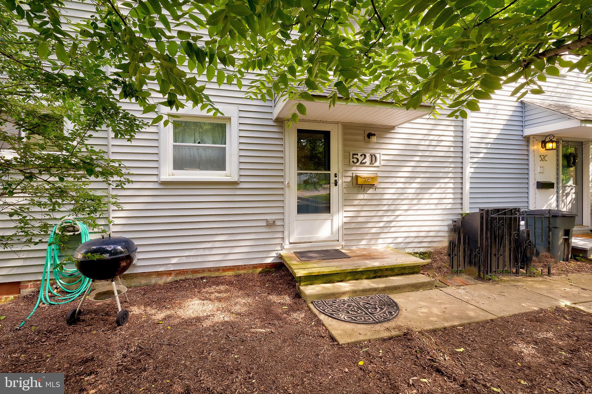 52 Ridge Road Greenbelt, MD 20770 - Photo 3 of 35 a view of a backyard with chairs and a tree