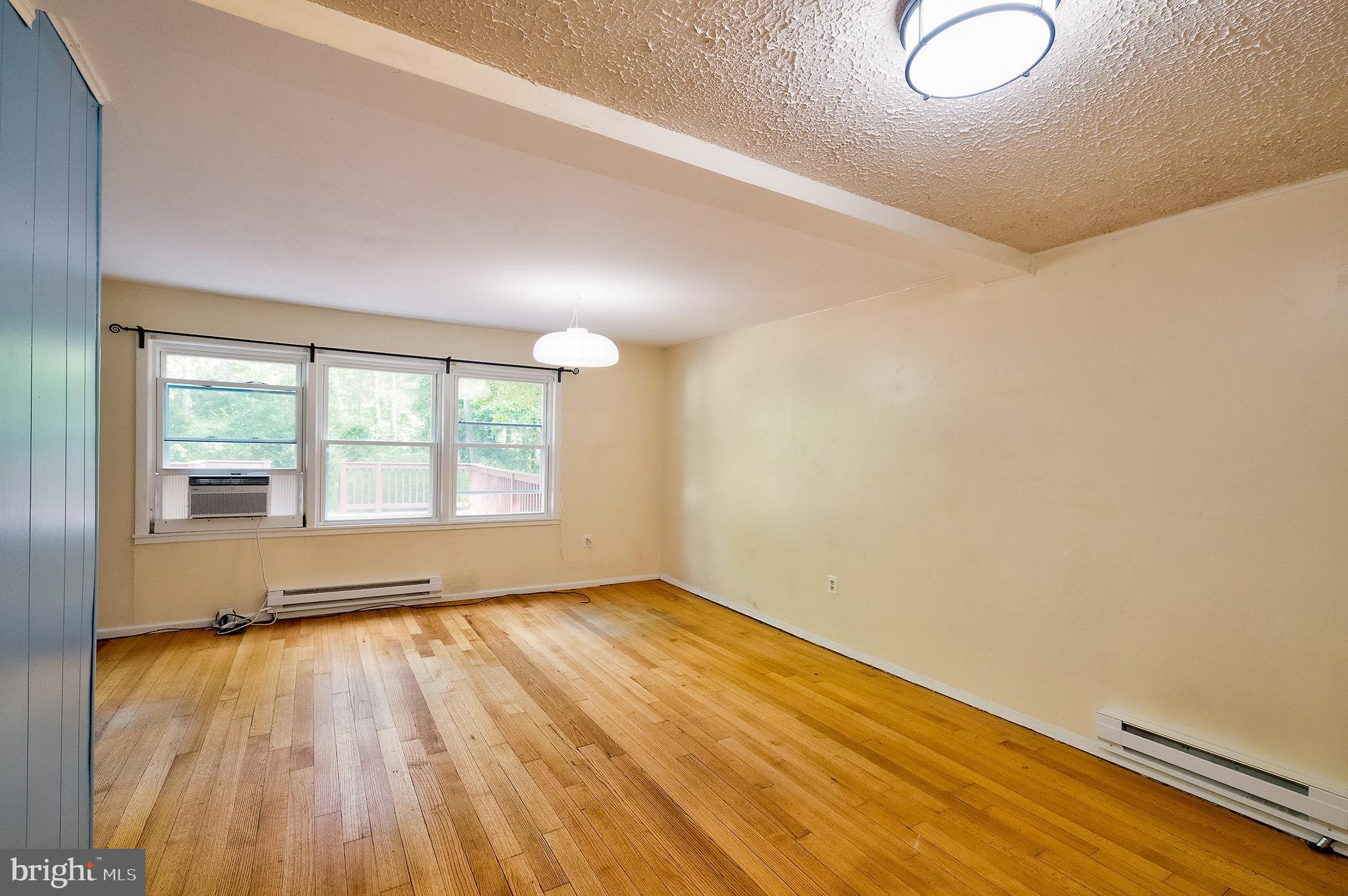 52 Ridge Road Greenbelt, MD 20770 - Photo 8 of 35 an empty room with wooden floor and windows