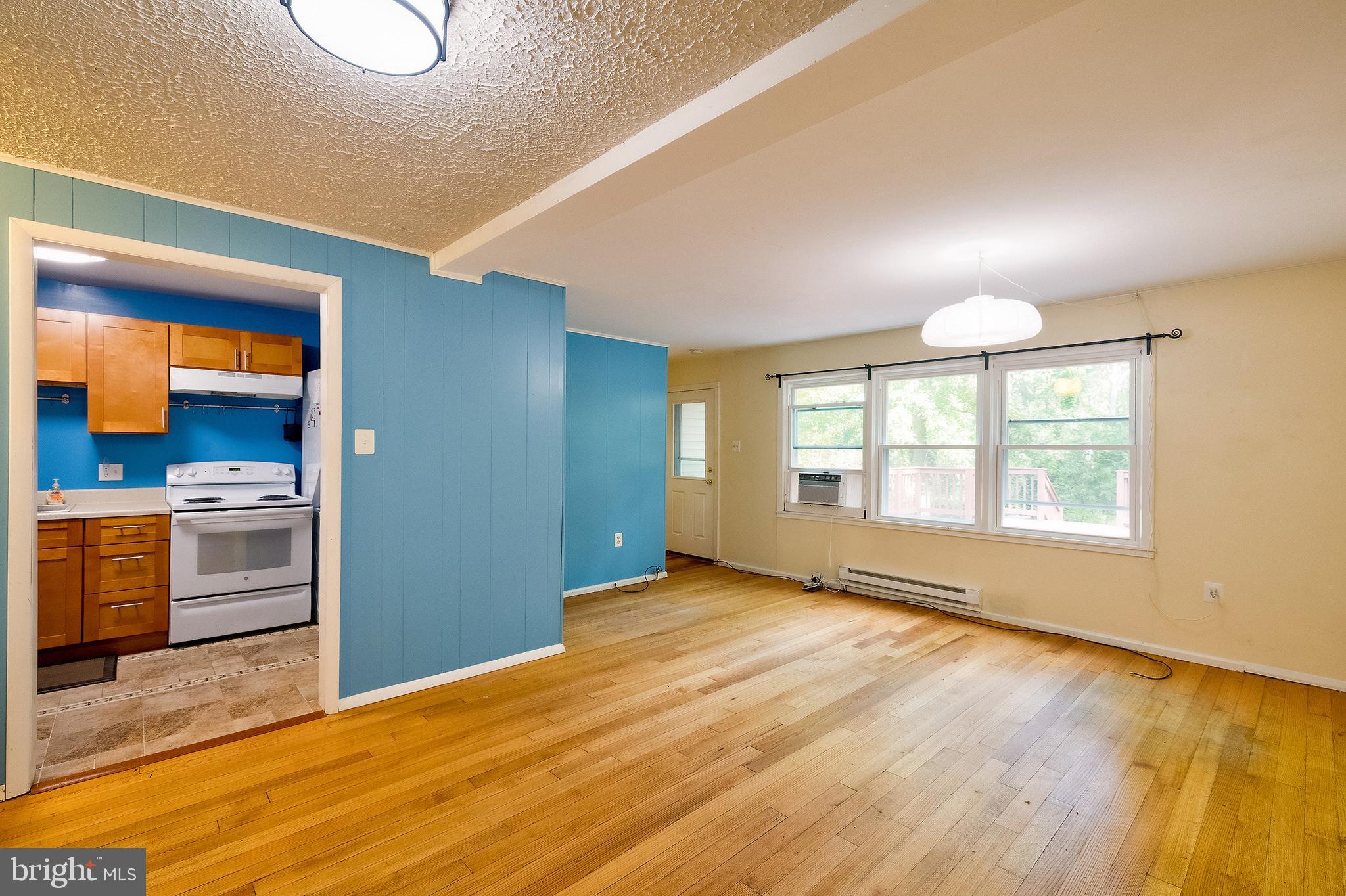 52 Ridge Road Greenbelt, MD 20770 - Photo 9 of 35 a view of an empty room with a window and wooden floor