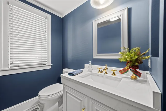 a bathroom with a sink a toilet and mirror