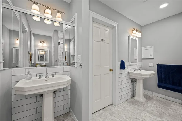 a bathroom with a sink double vanity and a mirror