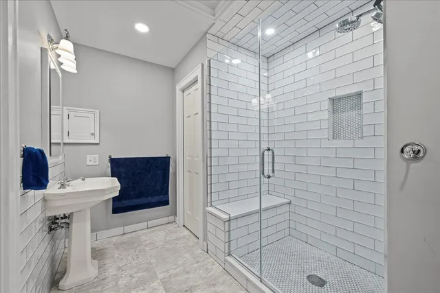 a bathroom with a sink a toilet and shower