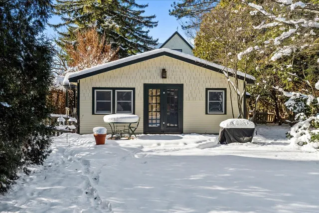 a front view of a house with sitting area