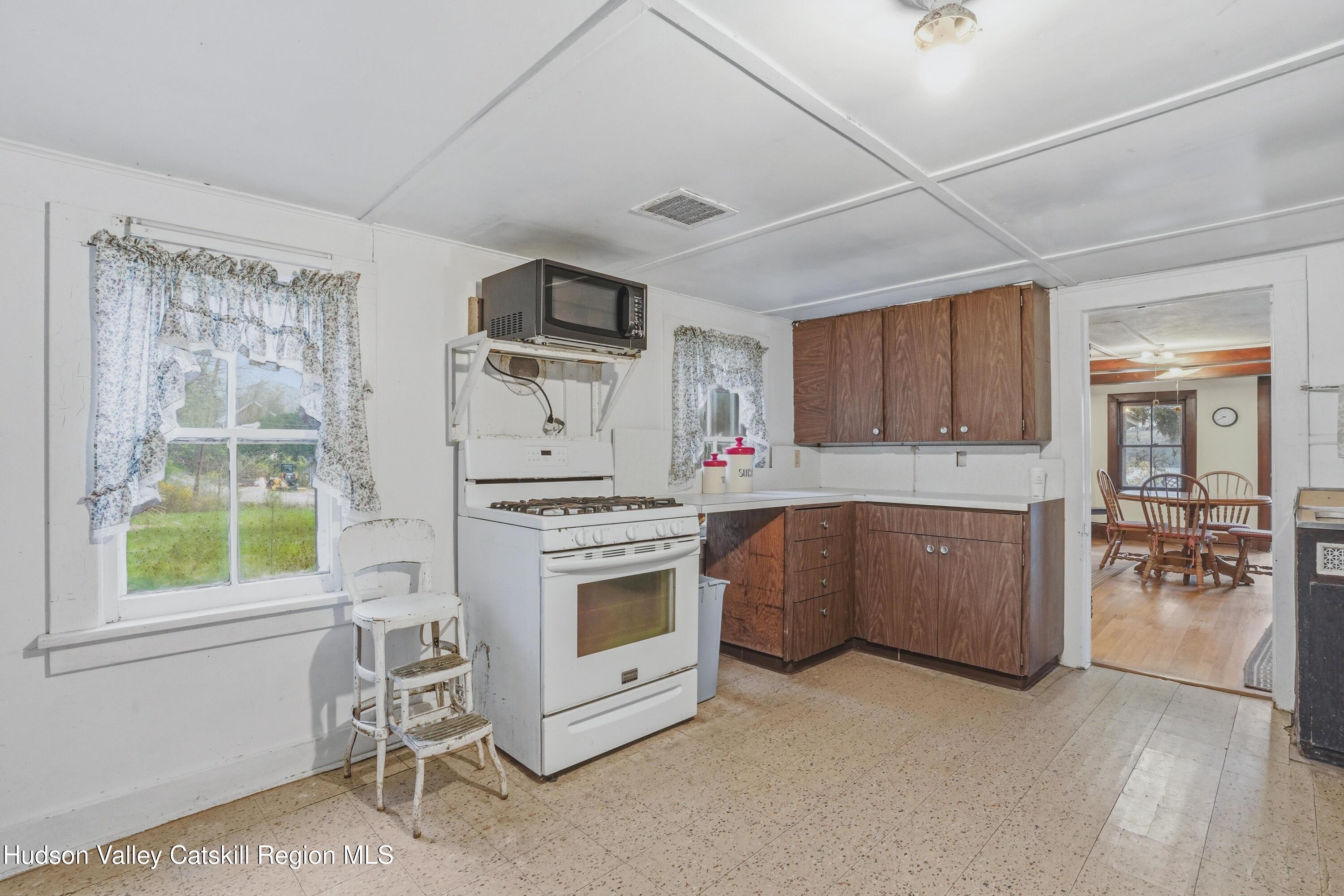 167 Patterson Road West Camp, NY 12490 - Photo 16 of 43 a kitchen with microwave a stove and furniture