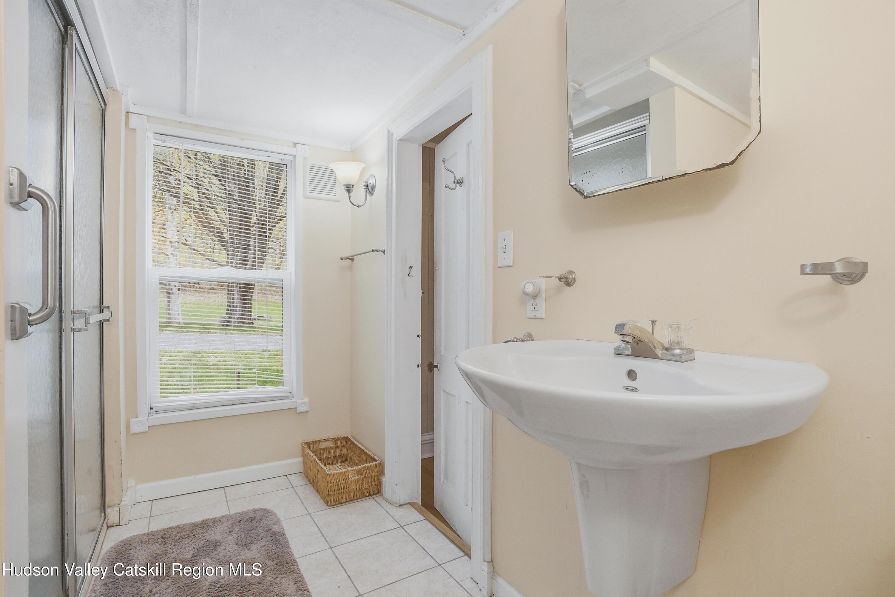 167 Patterson Road West Camp, NY 12490 - Photo 19 of 43 a bathroom with a sink a mirror and a window