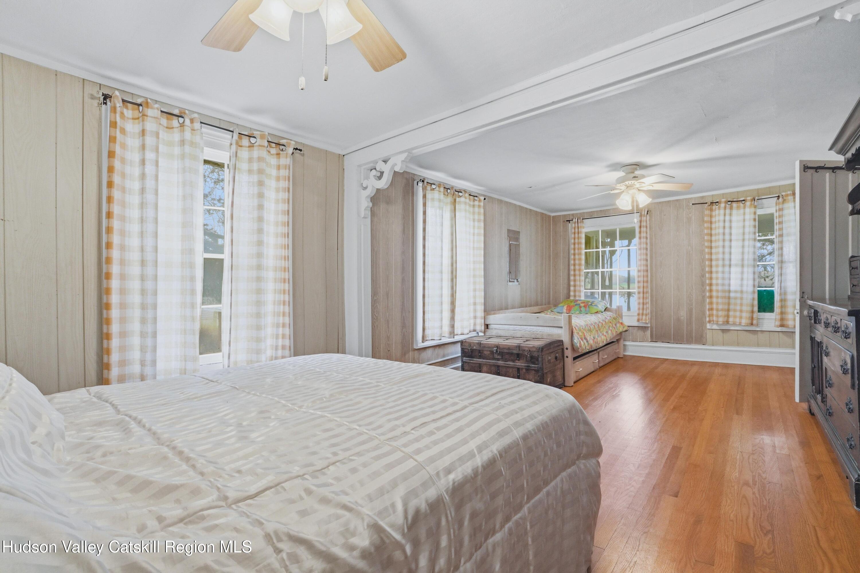 167 Patterson Road West Camp, NY 12490 - Photo 23 of 43 a spacious bedroom with a large bed and a large window