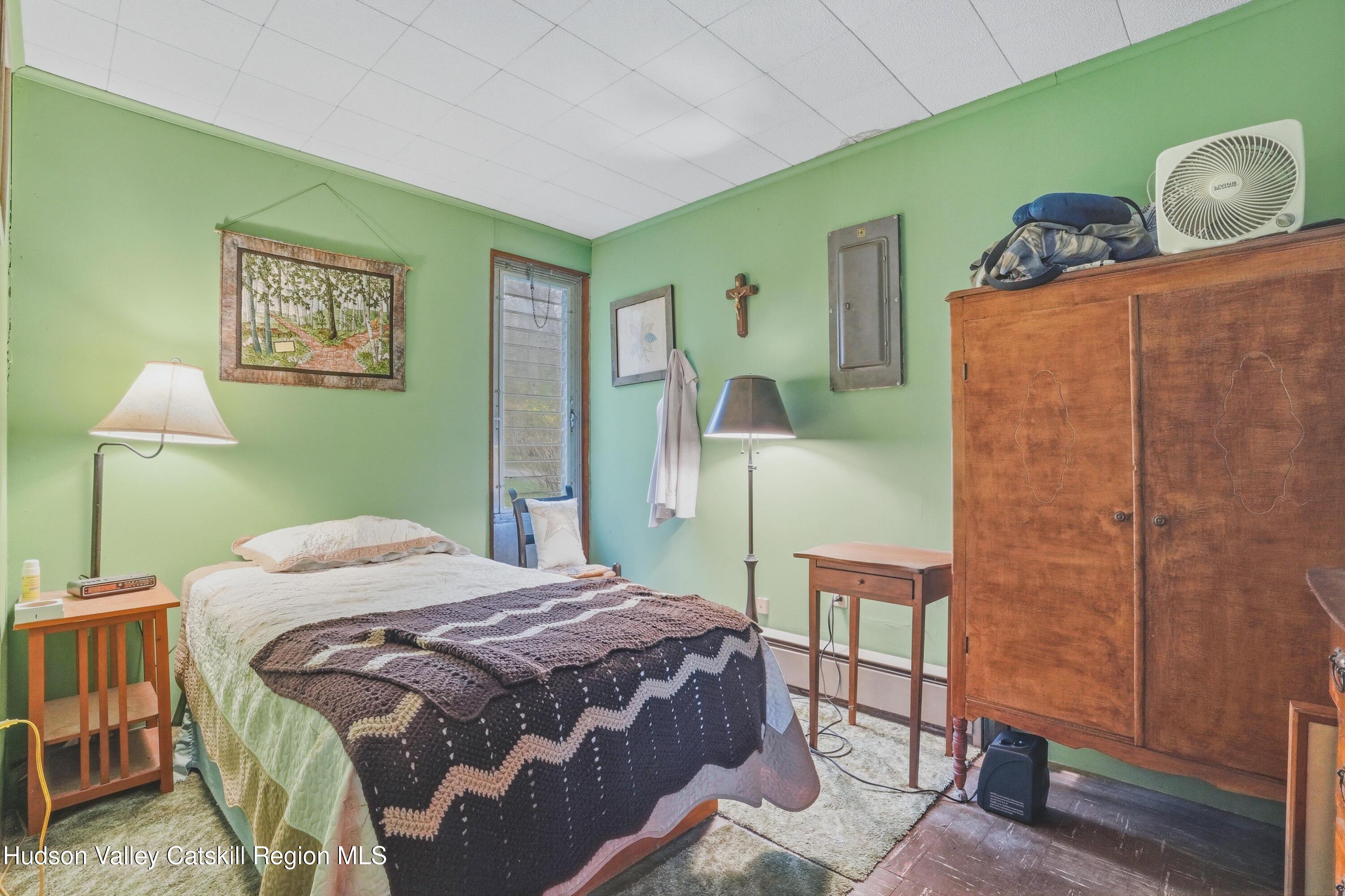 167 Patterson Road West Camp, NY 12490 - Photo 35 of 43 a bedroom with a bed and dresser with wooden floor