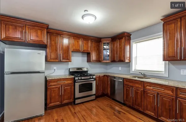 a kitchen with stainless steel appliances granite countertop a stove a sink dishwasher and a refrigerator