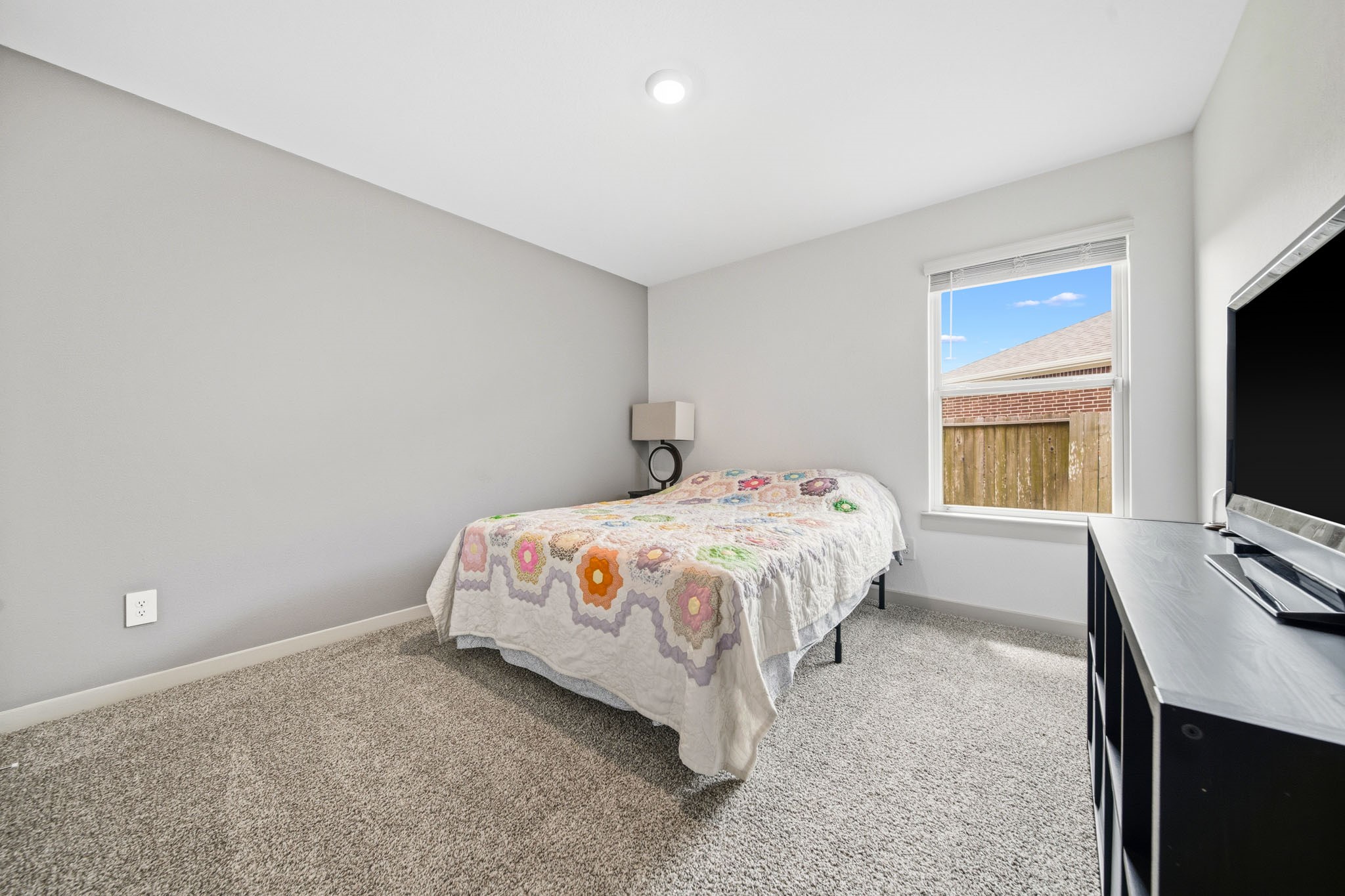 10207 Alpine Lake Lane Rosharon, TX 77583 - Photo 22 of 30 a bedroom with a bed and a flat screen tv