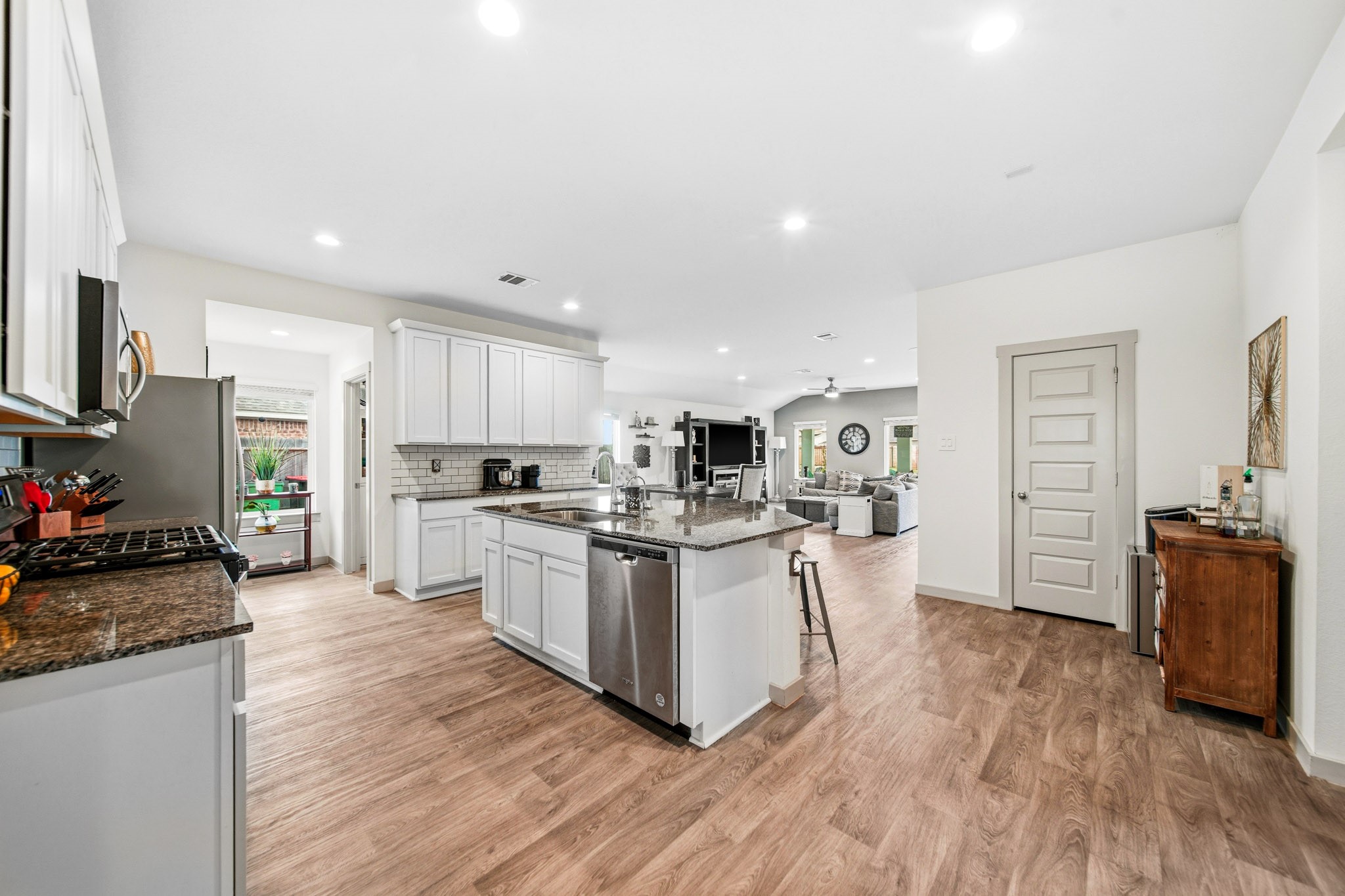 10207 Alpine Lake Lane Rosharon, TX 77583 - Photo 7 of 30 a kitchen with white cabinets and stainless steel appliances