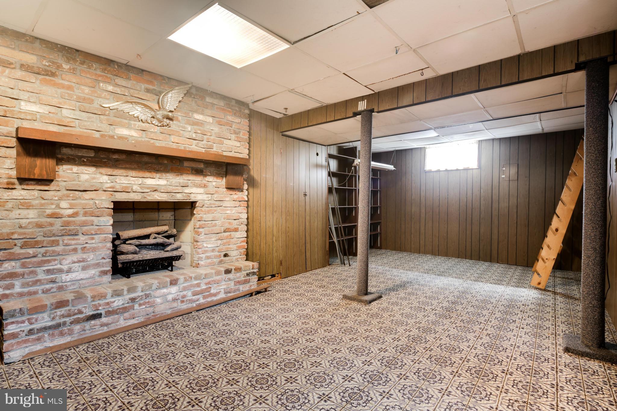 706 Dorchester Road Baltimore, MD 21229 - Photo 16 of 25 Club room with decorative fireplace