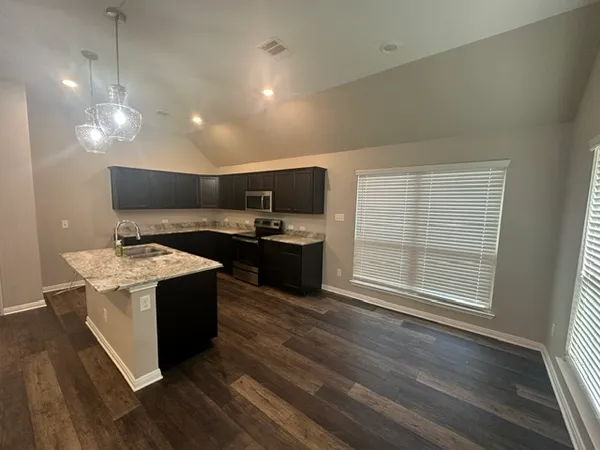 a kitchen with a stove and a sink