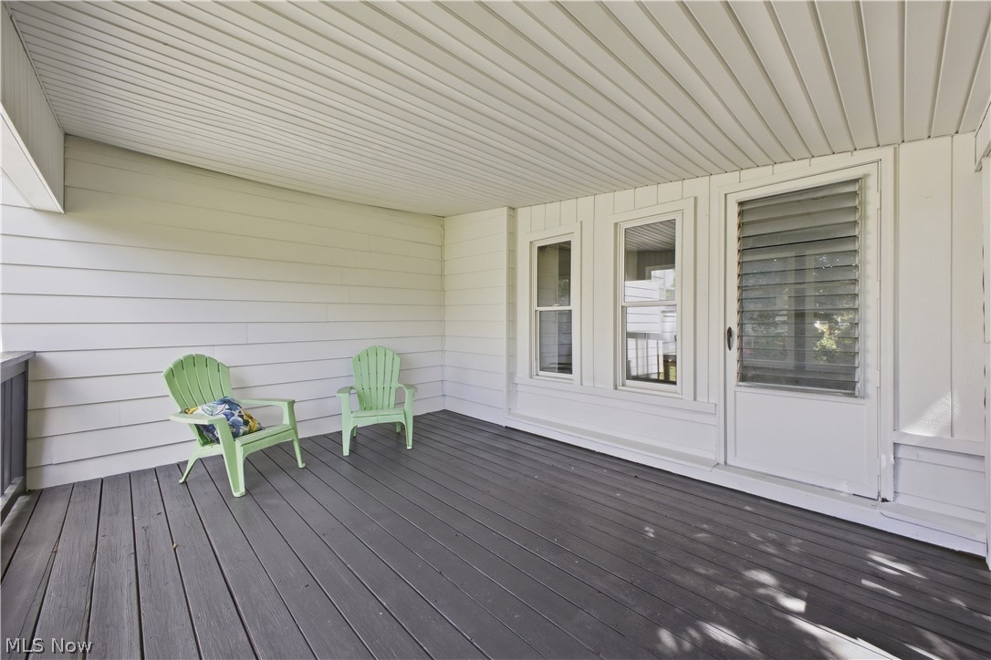 4845 New Road Austintown, OH 44515 - Photo 3 of 40 Covered porch with composite decking, white horizontal siding, and multiple windows
