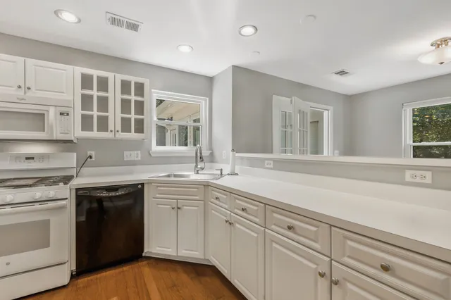 a kitchen with a sink stove and cabinets