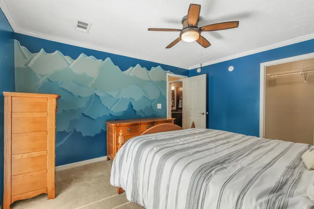 a bedroom with a bed and a chandelier