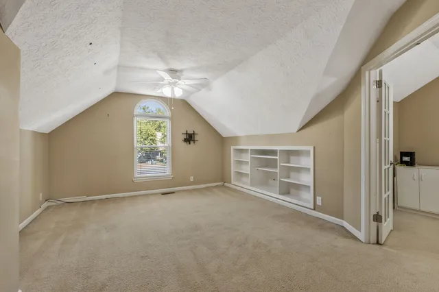 an empty room with a empty space and windows