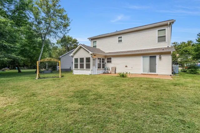a view of a house with a backyard