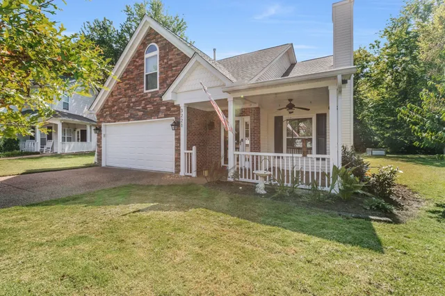a view of a house with a yard and plants