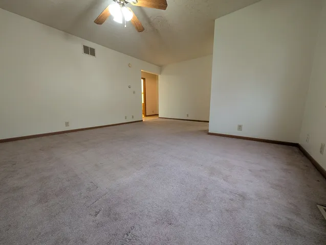 a hallway with a sink and a toilet