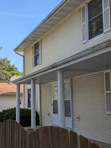 a view of a house with wooden fence