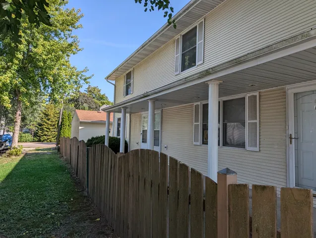 a house that has a tree in front of it